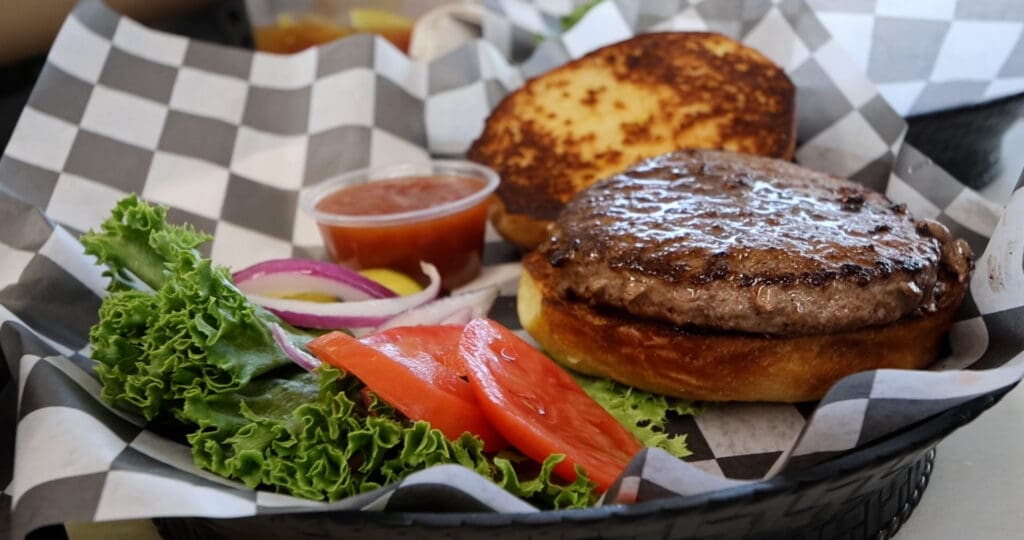 The Custer Burger served with lettuce, tomatoes and onions.